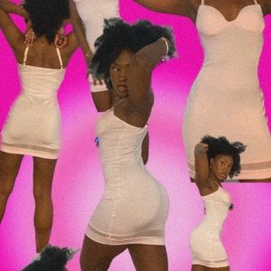 This dress is a pale pink and a size small! It is perfect for a sexy night out!